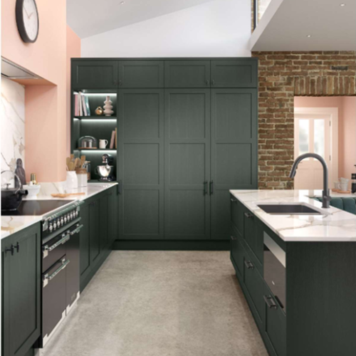 Modern bespoke kitchen in Dublin with dark green cabinets and exposed brick.