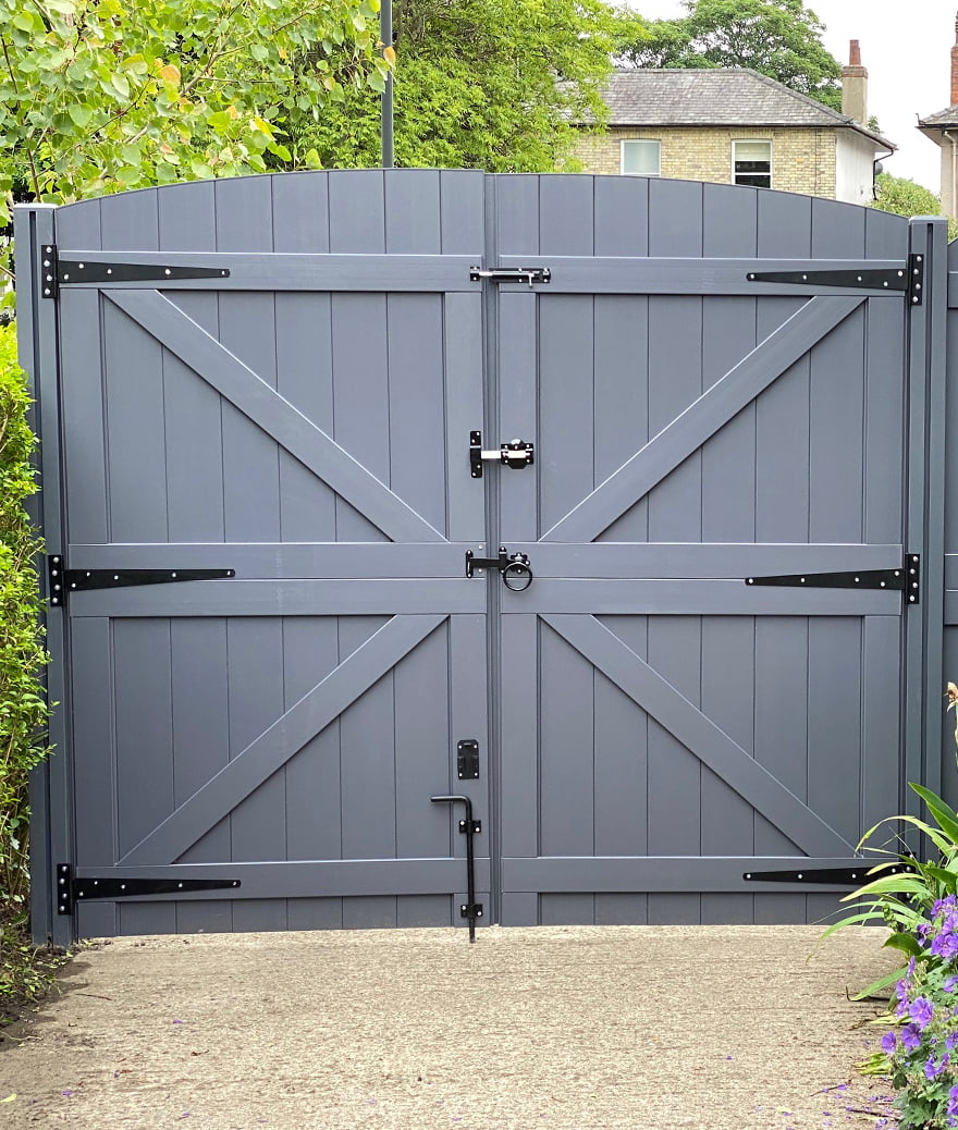 Charcoal grey bespoke wooden driveway gates with diagonal cross bracing.