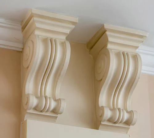 Ornate timber corbels in high ceiling.