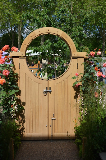 Bespoke wooden garden gate with round top.