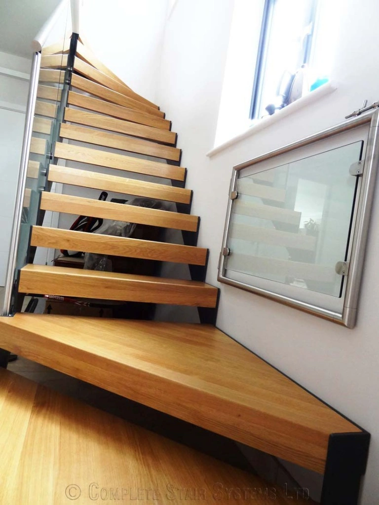 Floating wooden staircase with glass railing.